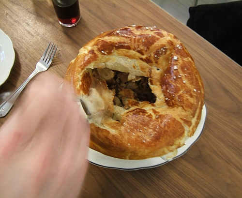 Cracking into the offal-rich pot pie.